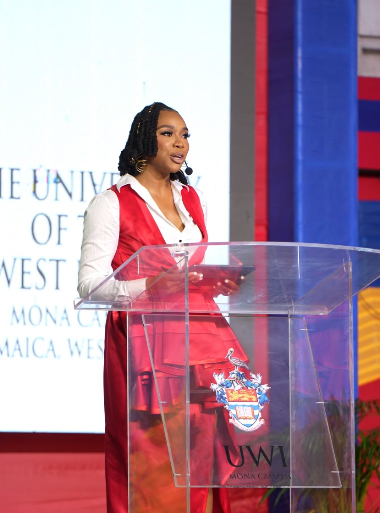 Krystal hosting at UWI Mona Campus behind a branded podium.