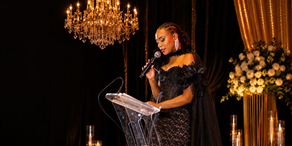 Krystal Tomlinson speaking at podium